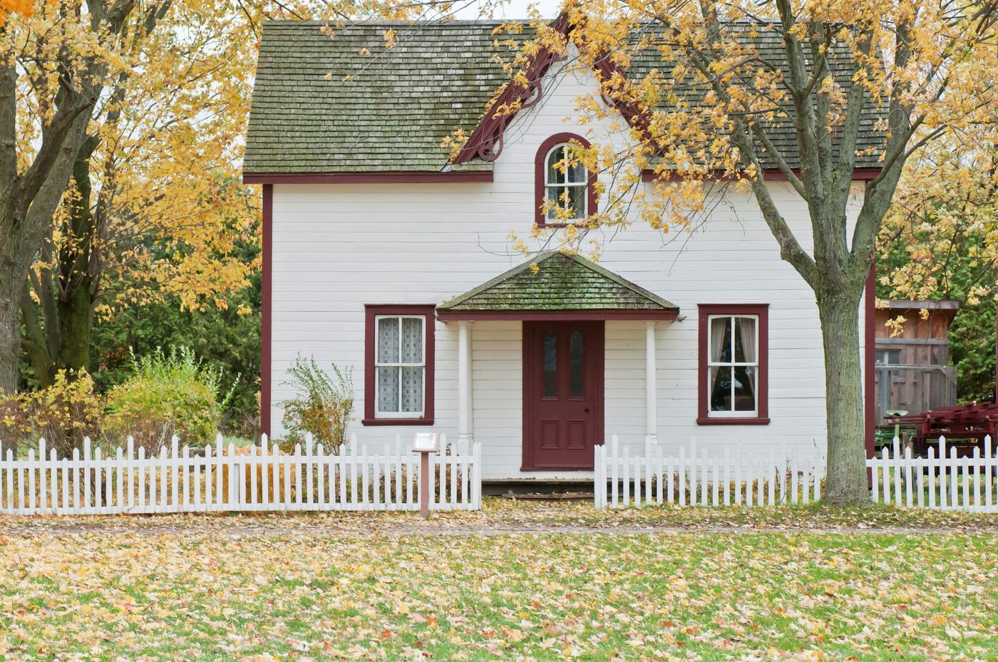 A charming single-family starter home with a white picket fence, ideal for first-time buyers